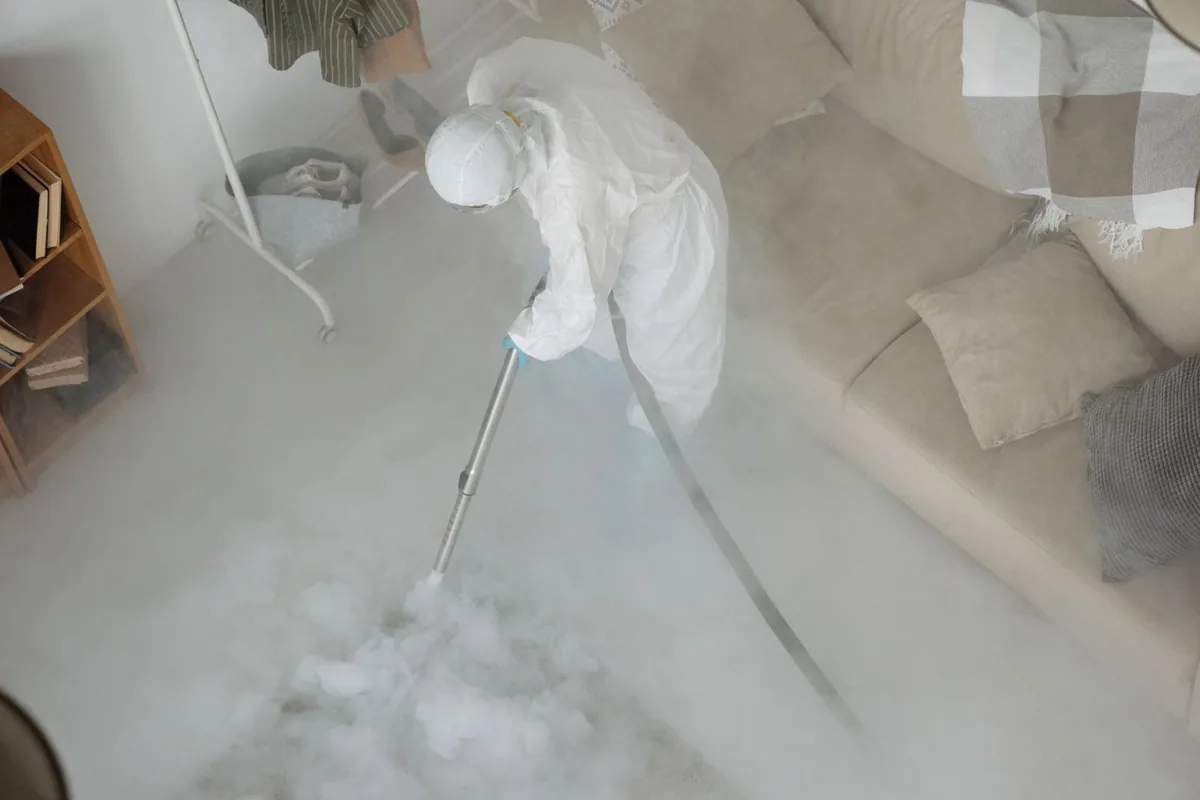 Biohazard cleanup technician in protective equipment, Mora, MN